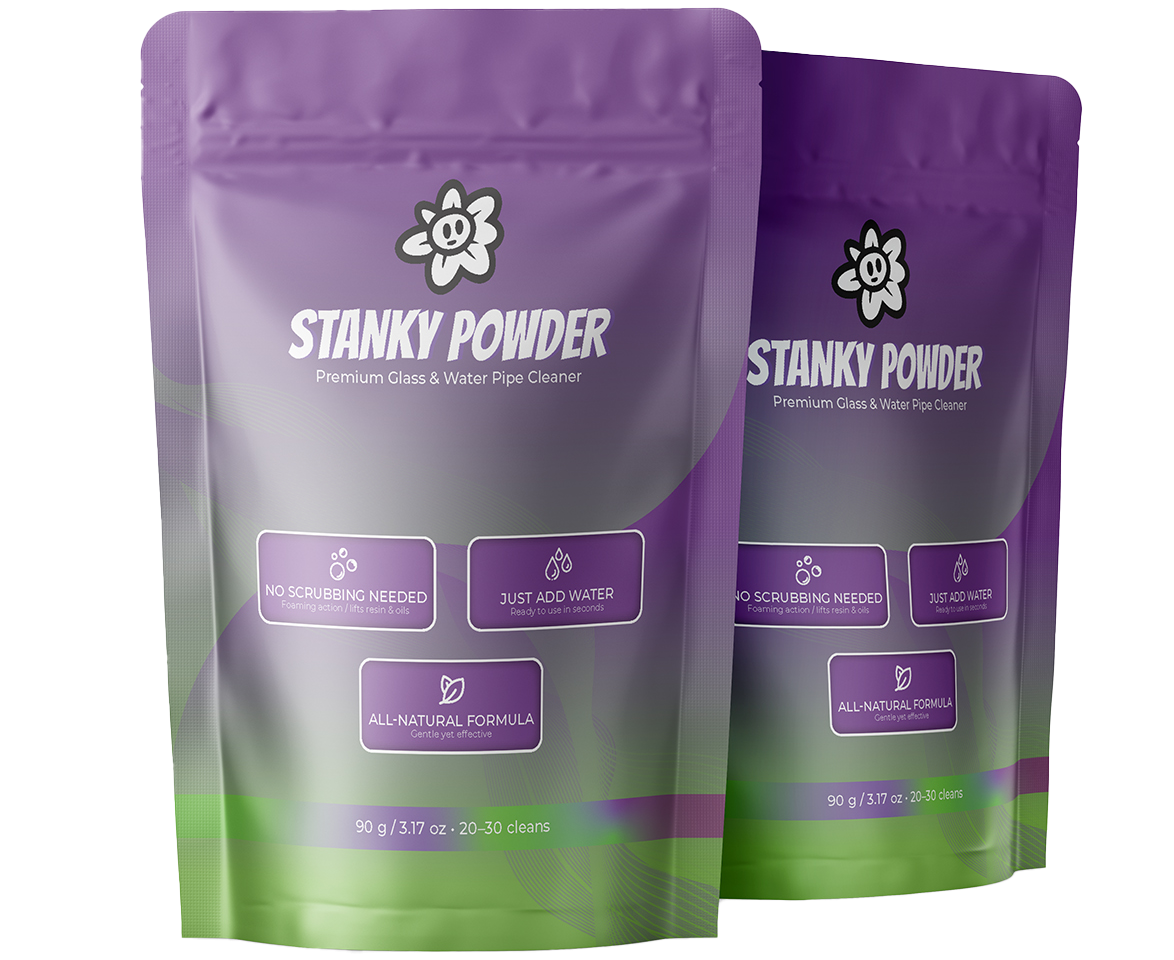 Two purple and green packages of 'Stanky Powder' on a white background